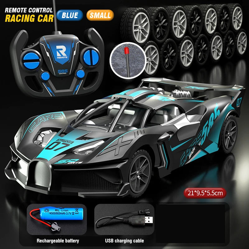 Carro RC teledirigido gris con detalles azules; mando negro y ruedas visibles.