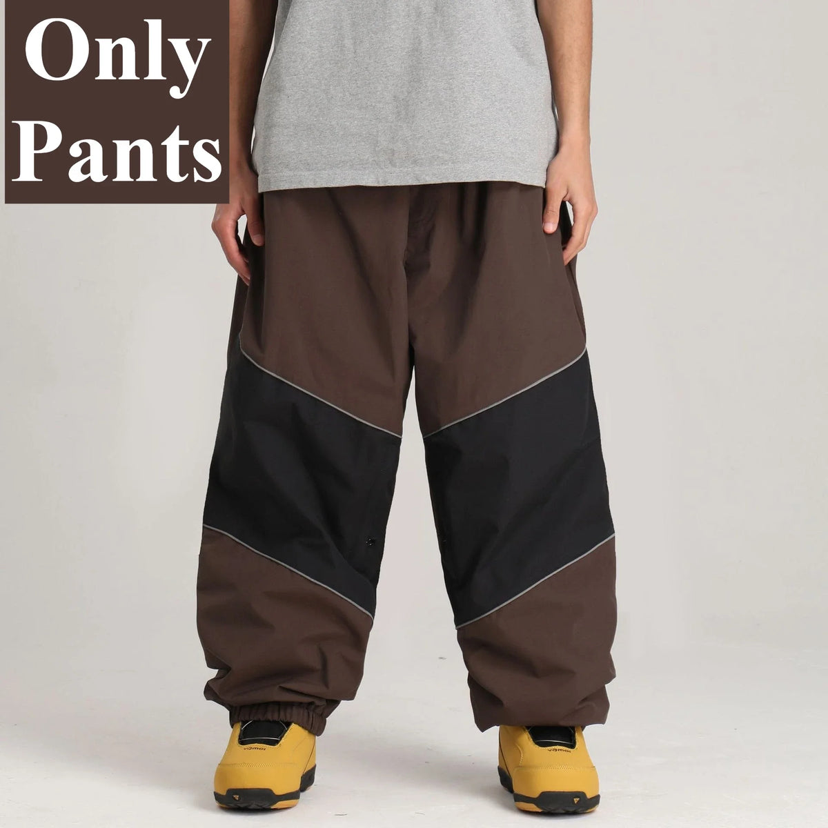 Pantalones de snowboard holgados para hombre GSOU SNOW, con diseño de bloques de color, impermeables, resistentes al viento, transpirables y con detalles reflectantes.