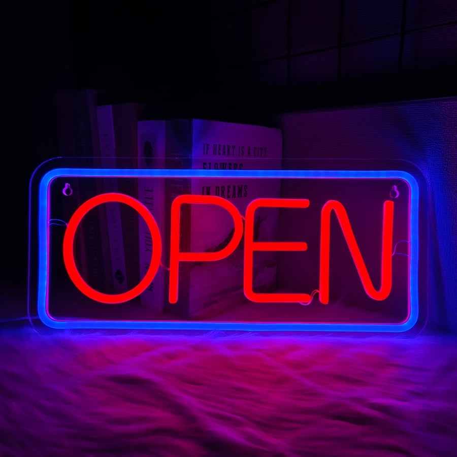 Letrero de neón con texto OPEN, marco azul y letras rojas