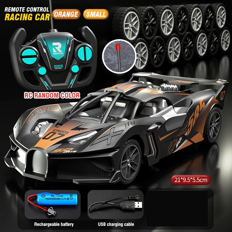 Carro RC teledirigido gris con detalles naranjas; mando negro y ruedas visibles.