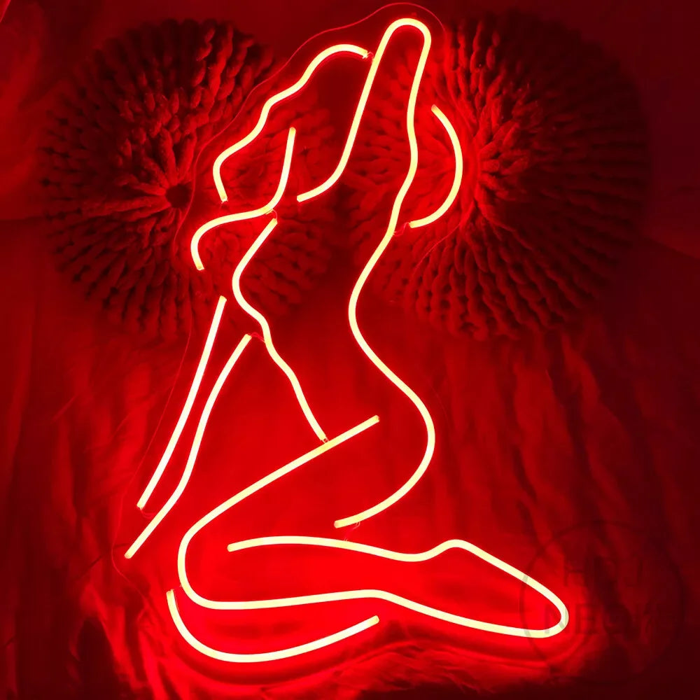 Letrero de neón LED rosa con silueta femenina de pie, brazos levantados