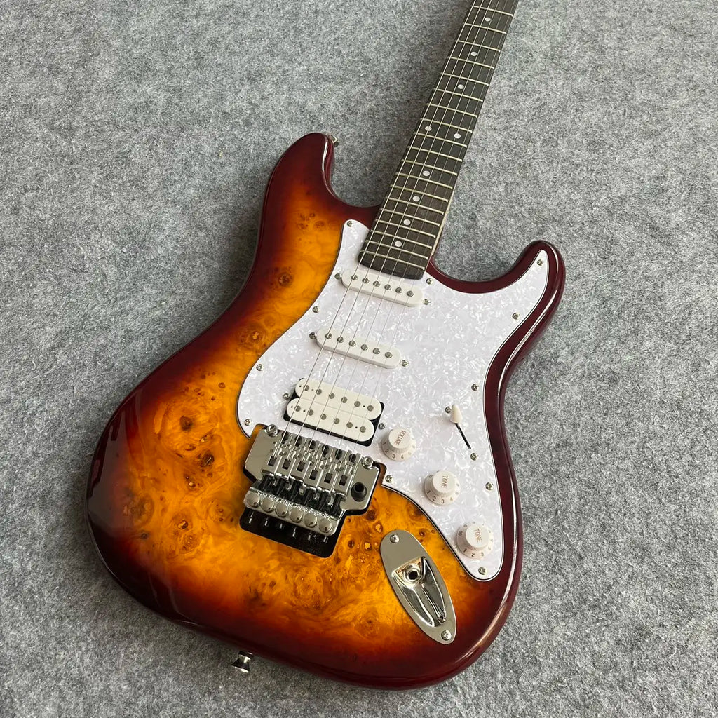 Guitarra de alta calidad con acabado Sunburst, incrustaciones de estrellas, sistema de trémolo y pastillas SSH 2026