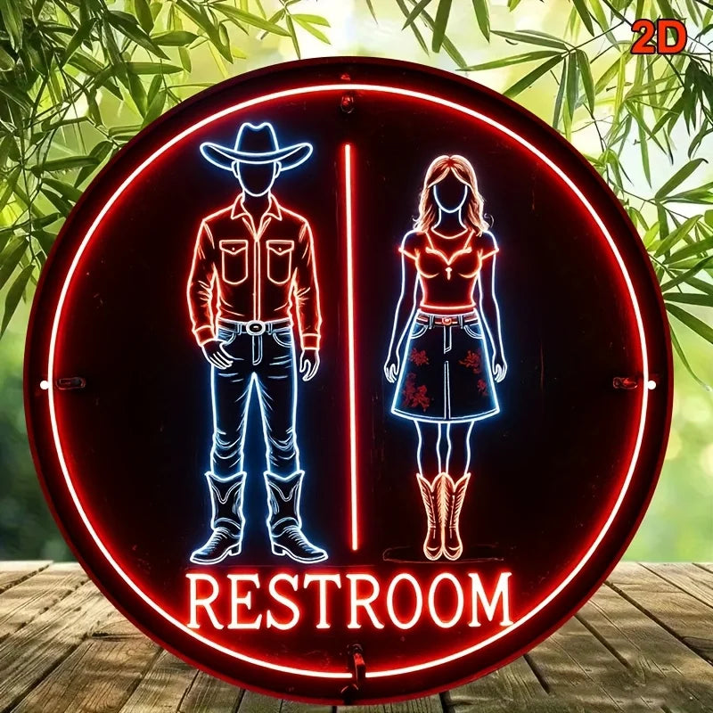 Cartel redondo de neón con vaquero y vaquera, borde rojo y texto “RESTROOM”.