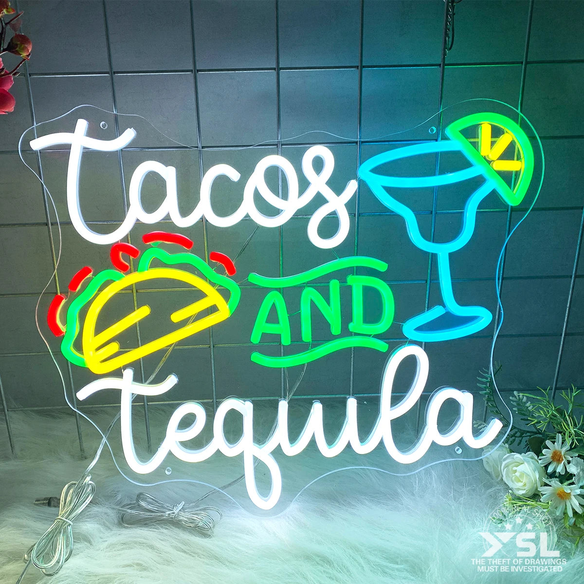 Letrero de neón con texto 'Tacos And Tequila' en letras blancas y colores vivos.