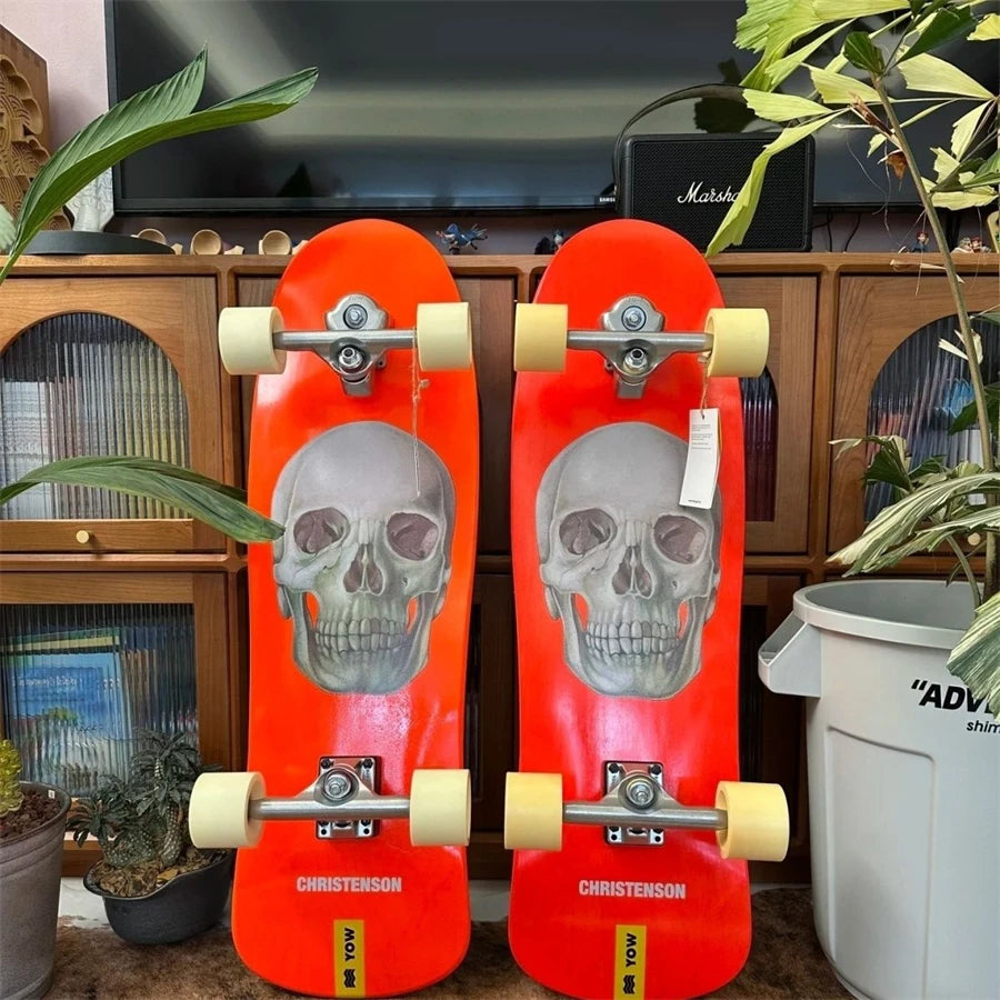 Patineta de surf YOW Land, modelo CHRISTENSON, diseño de calavera naranja, 34 pulgadas, con laterales curvos dobles, calidad profesional.