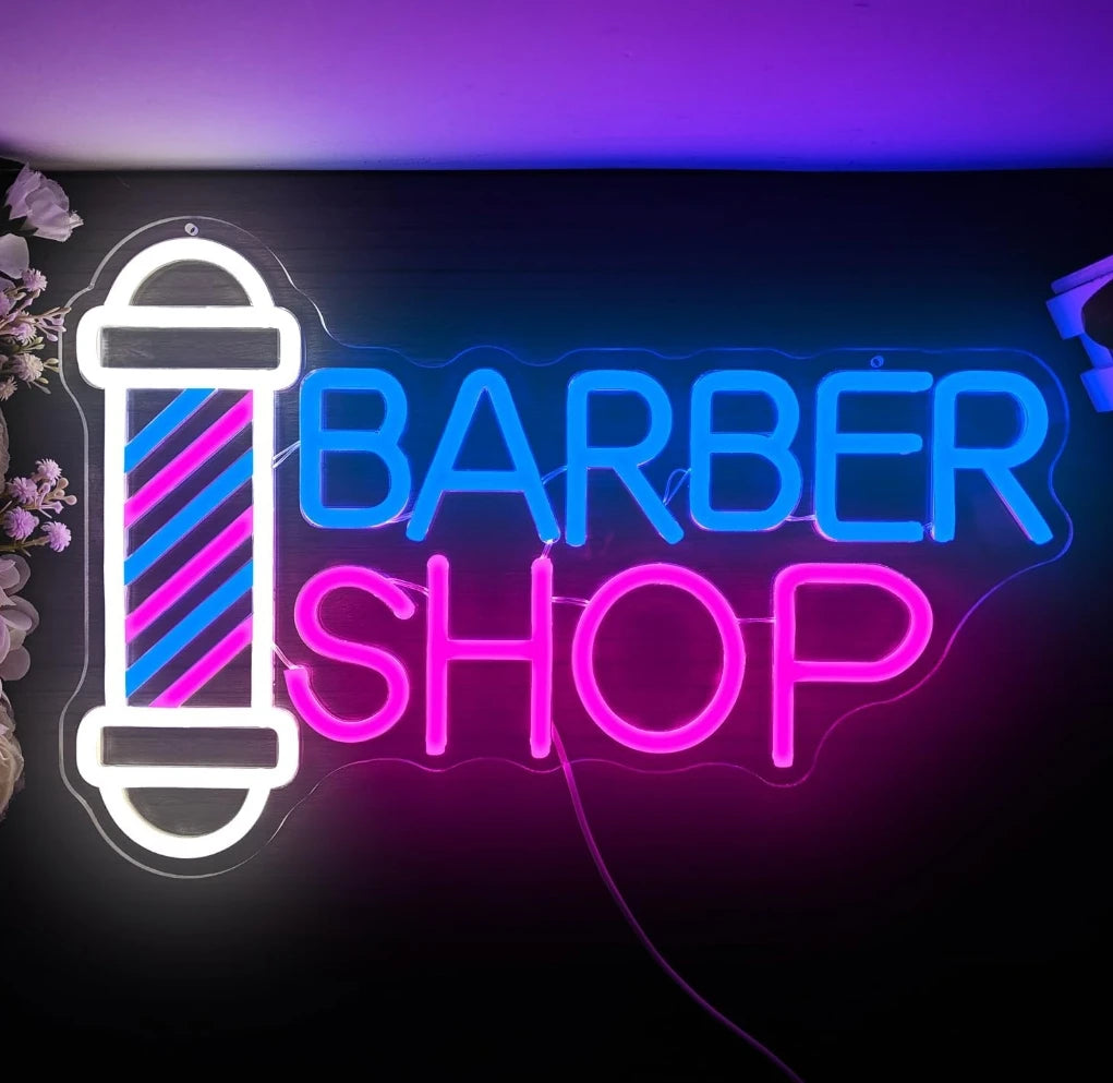 Rótulo de neón «BARBER SHOP» con poste y texto luminoso en varios colores