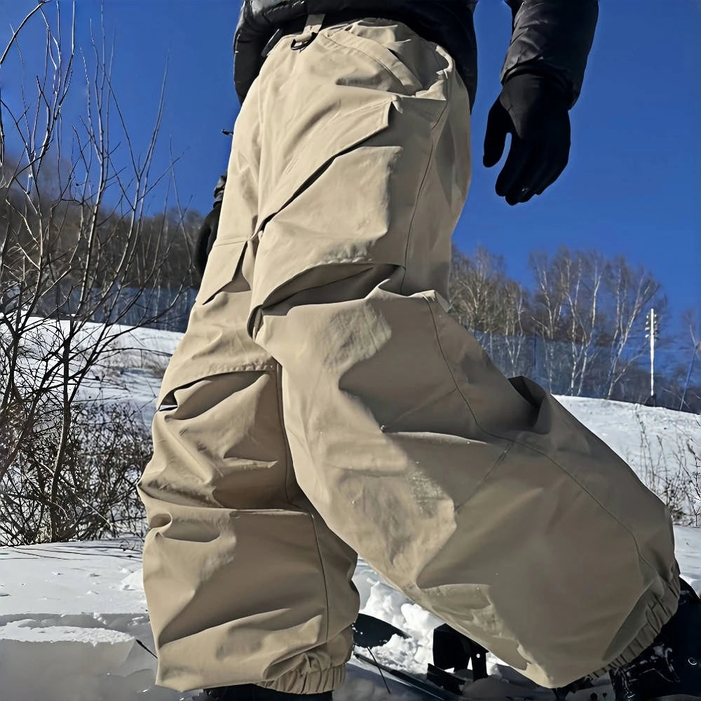 Pantalones de esquí holgados resistentes al desgaste para hombre, pantalones de invierno con bolsillos sueltos aislados para mujer, ropa impermeable para deportes al aire libre, cálida 2025