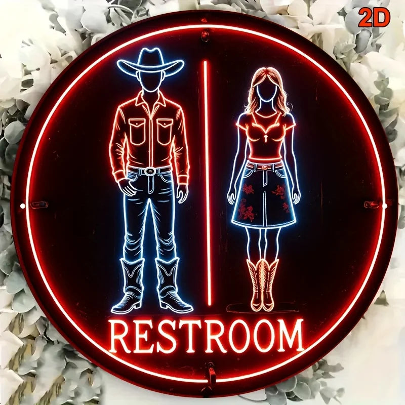 Cartel circular de neón con vaquero y vaquera, borde rojo y texto “RESTROOM”.