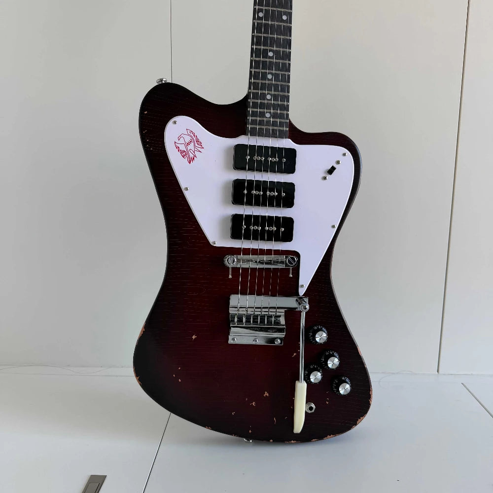 Guitarra eléctrica de cuerpo macizo con diseño único, acabado en color marrón envejecido y con efecto desgastado, tres pastillas de bobina simple y puente con trémolo.